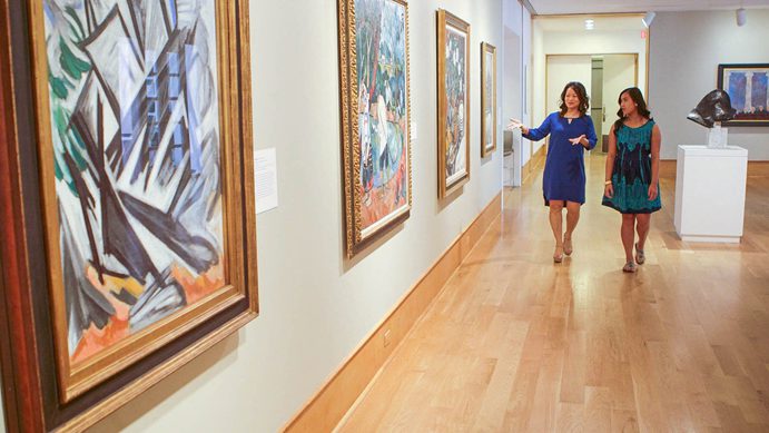 Two women walk in a gallery at Des Moines Art Center, where admission is free
