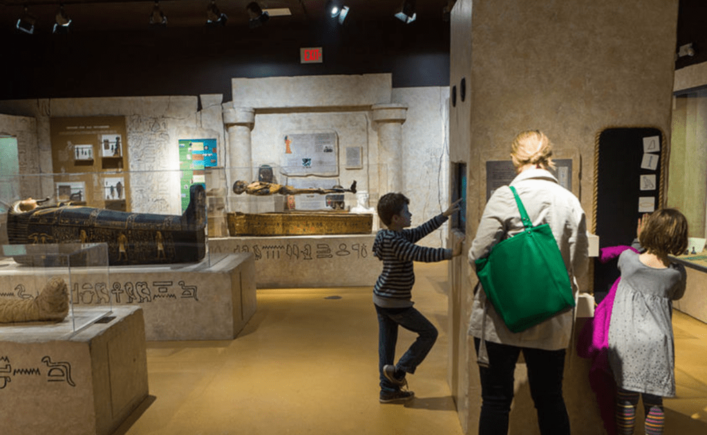 A family looks around an exhibit on Egypt at the Putnam Museum & Science Center in Davenport, Iowa