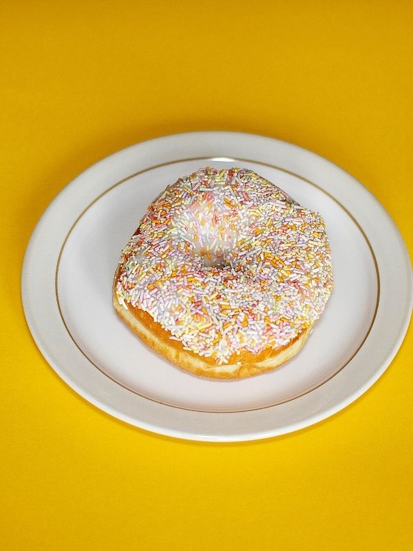 An overhead shot of a sprinkle donut 