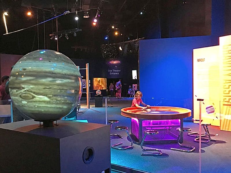 A girl interacts with an exhibit inside the Science Center of Iowa in downtown Des Moines