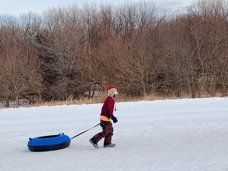 A girl with a snow tube at Seven Oaks Recreation