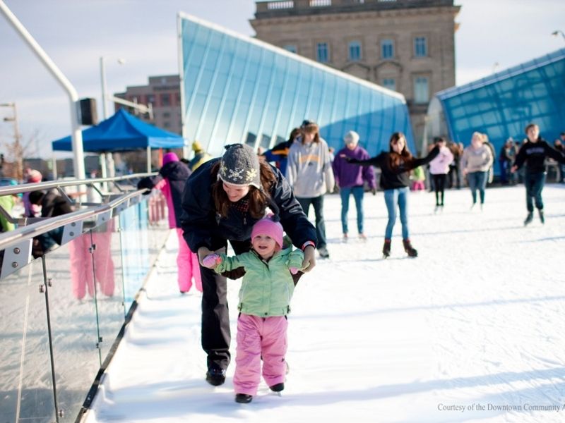 A mother and daughter ice skate at Des Moines' Breton Skating Plaza