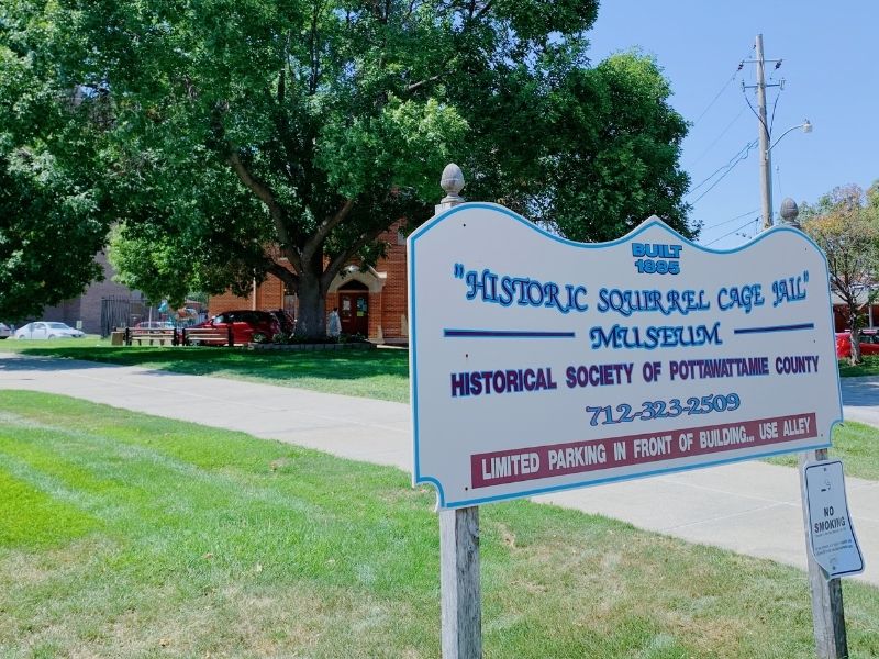 A sign in front of the Squirrel Cage Jail Museum