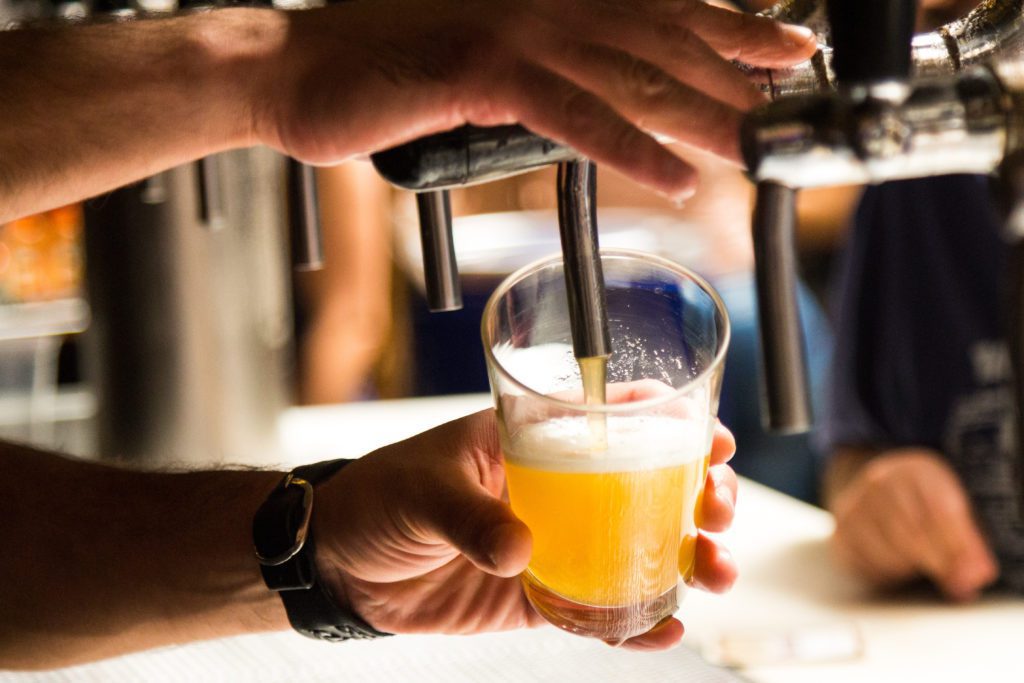 A beer being poured into a pint glass