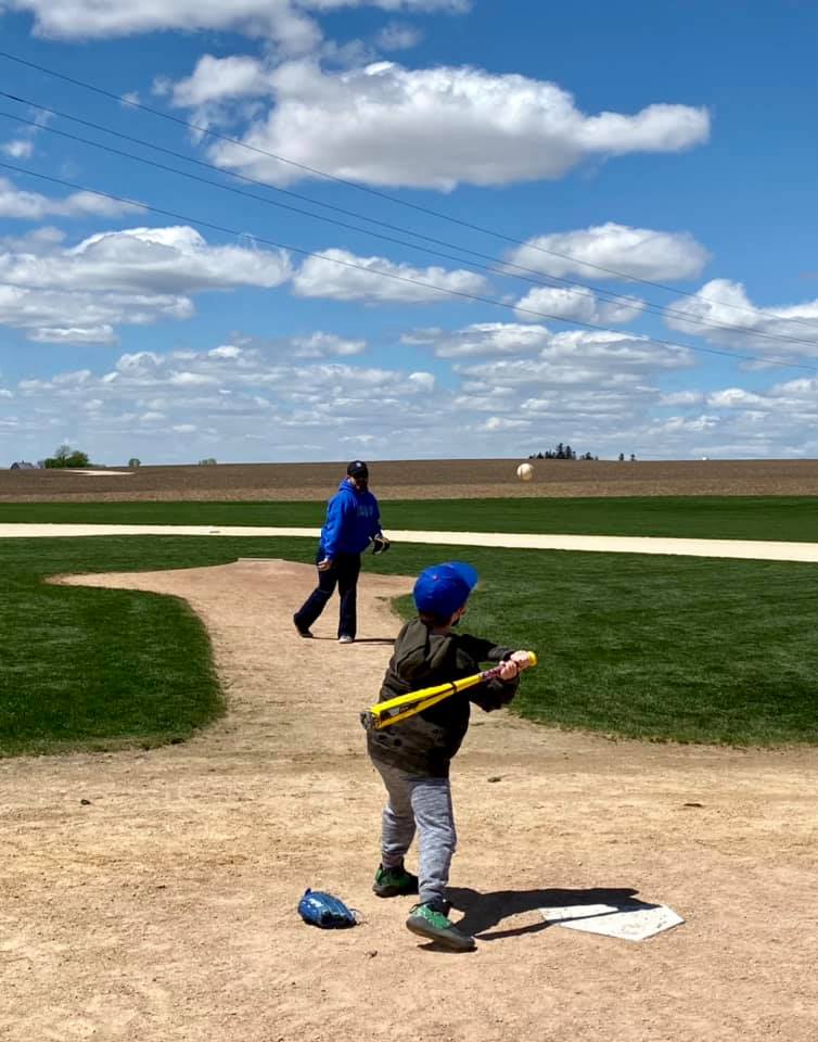 Dad and son play ball at the Field of Dreams Movie Site in Iowa