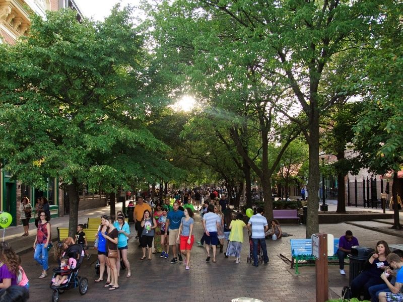 A crowd strolls the Pedestrian Mall in Iowa City