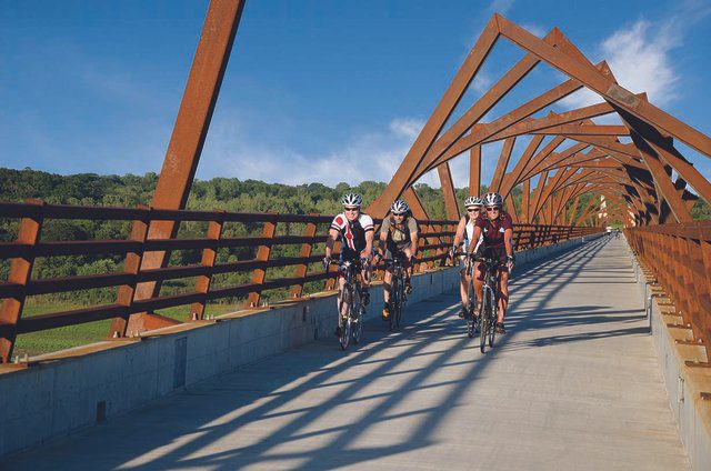 Cyclists on the High Trestle Trail Bridge