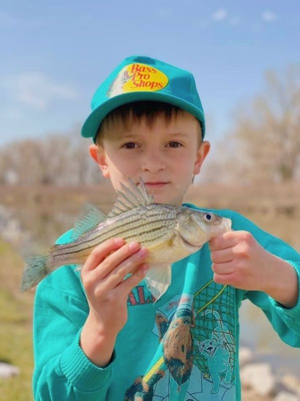 A boy holding up the fish he caught at Lake Manawa Statte Park