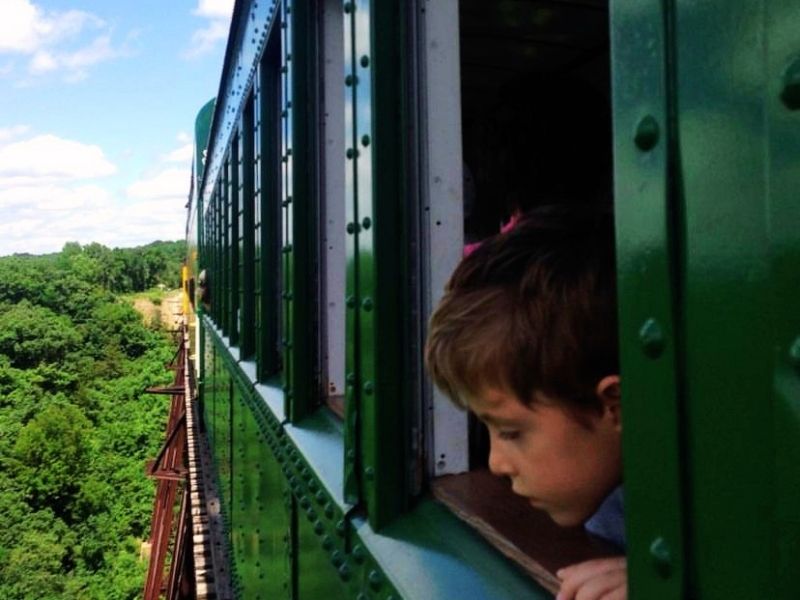 A boy peeks out a window of the train on the Boone & Scenic Valley Railroad in central Iowa 