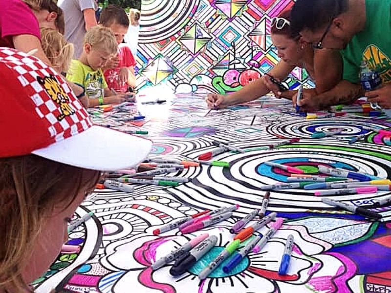Kids color on a project at Des Moines Art Festival