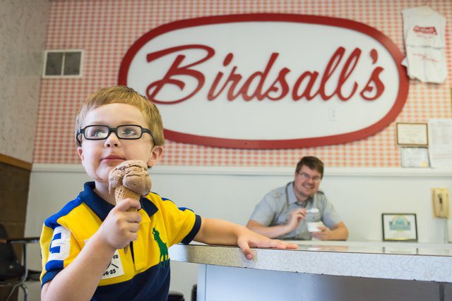 A boy eats an ice cream cone at Birdsall's