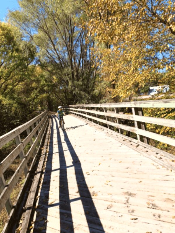 A child rides on a bridge along the Wabash Trace Trail