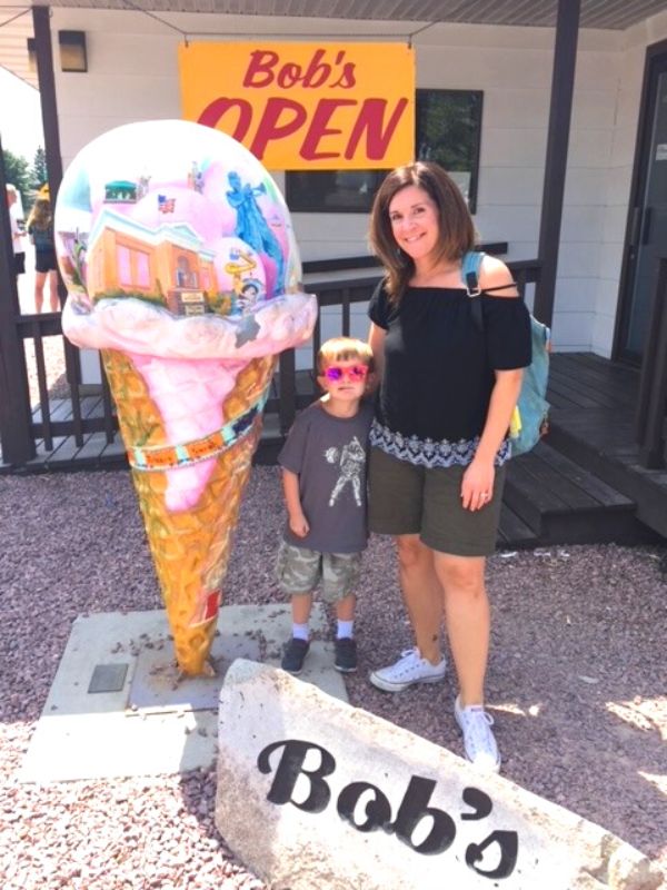 Tiffany and son in front of a huge ice cream cone at Bob's Drive Inn in LeMars, Iowa
