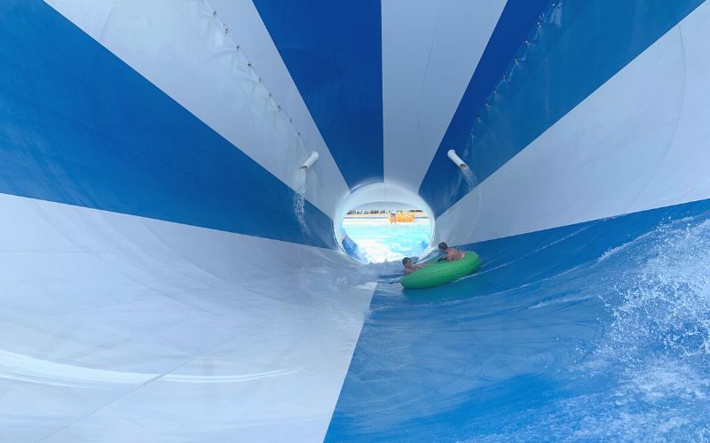 Two kids on a tube on the Molokini Crater water slide.