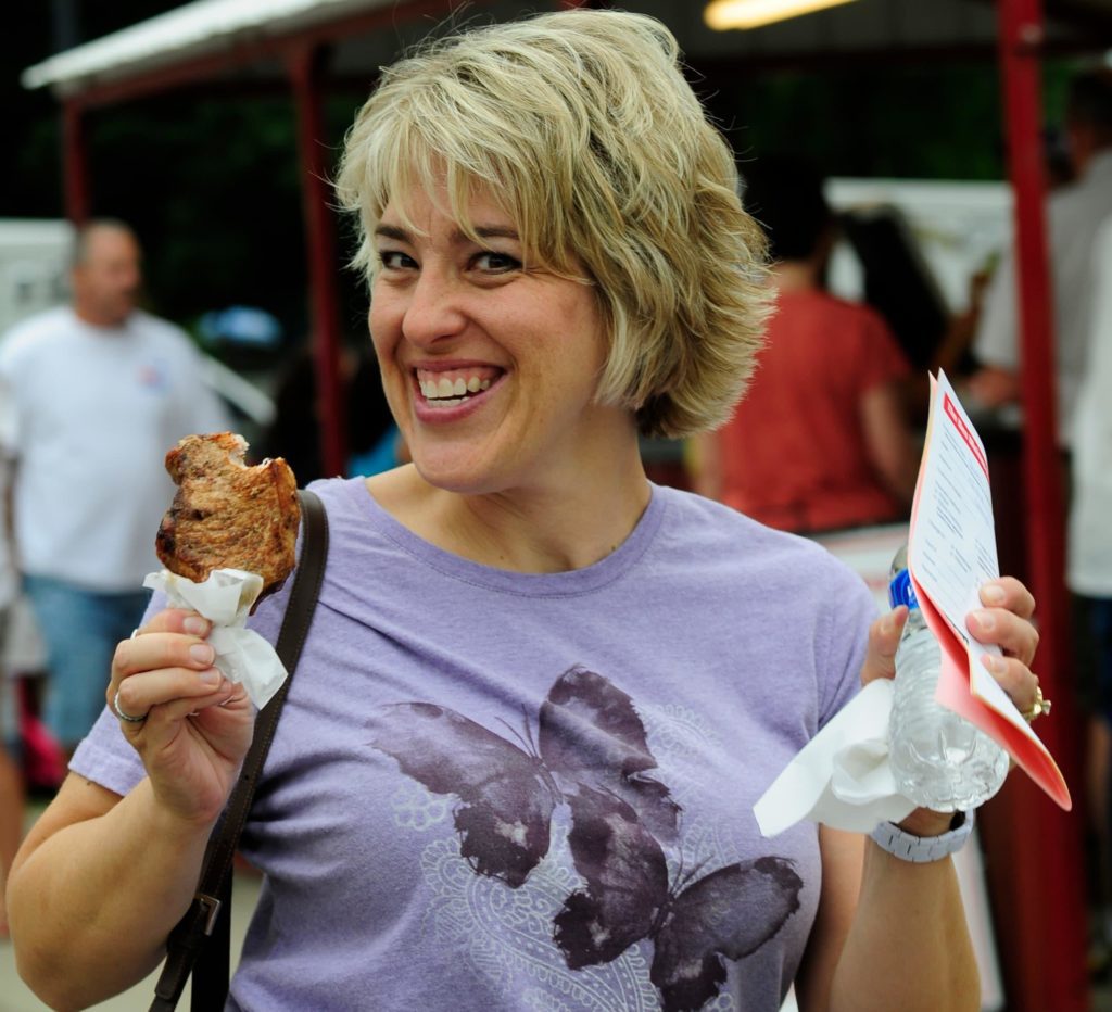 Woman with a pork chop on a stick at the Iowa State Fair