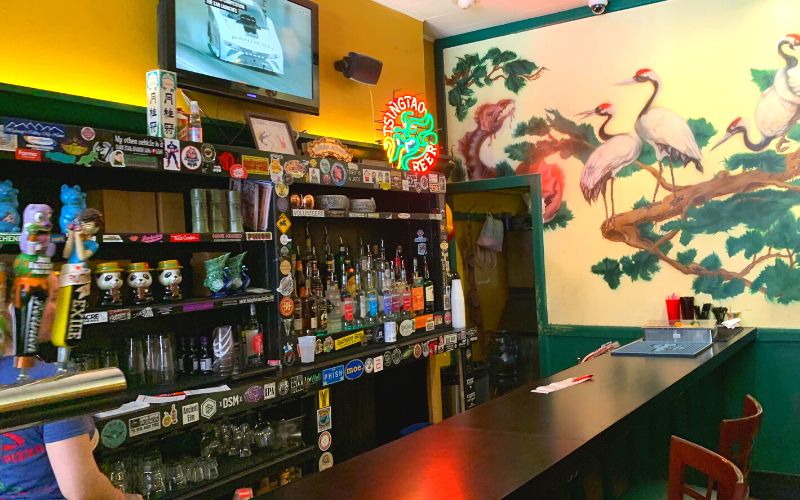 The bar and a mural at the downtown Des Moines Fong's Pizza location 