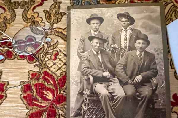 A black and white photograph of four men on display at Bedstemor's House in Elk Horn, Iowa