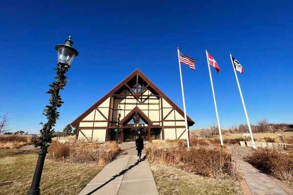 Exterior of the Danish American Museum in Elk Horn Iowa, with three flags in front - the American flag, Danish flag and Iowa flag