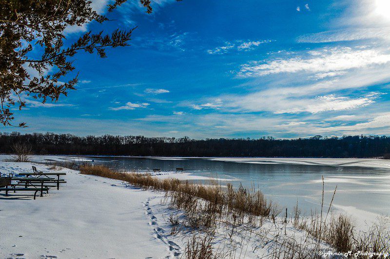 Snow-covered ground and half-dozen water at George With State Park