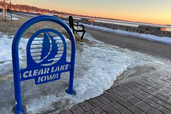 The Clear Lake lakefront in the winter, with icy snow patches near a bench