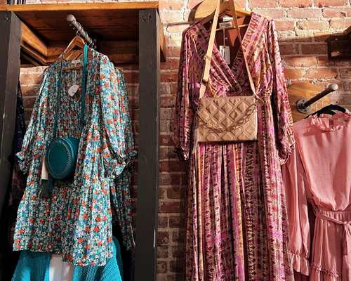 Dresses on display at Dusted Charm, a boutique located on the 100 Block of Broadway in Council Bluffs