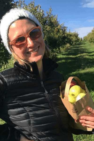 Kim with a bag of apples at Ditmars Orchard & Vineyard