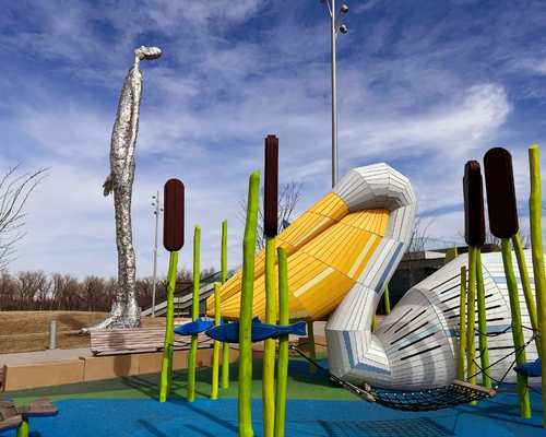 A pelican playground piece and public art in the background at Tom Hanafan's River's Edge Park in Council Bluffs