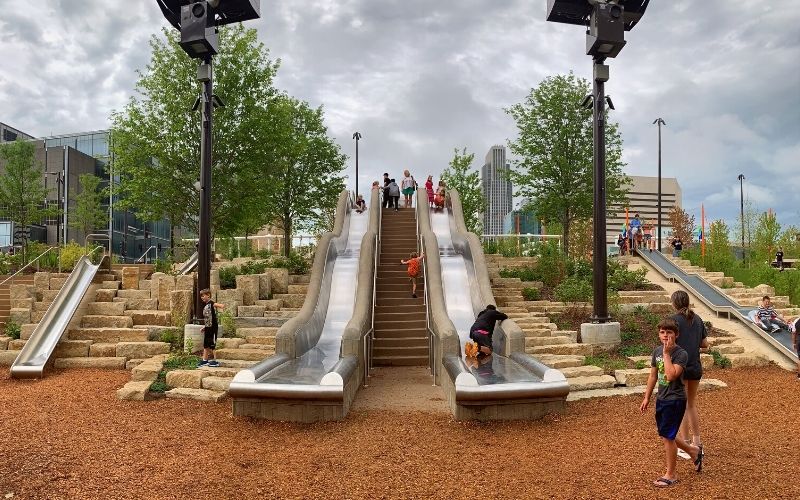 Children slide down the slides at Gene Leahy Mall in Omaha