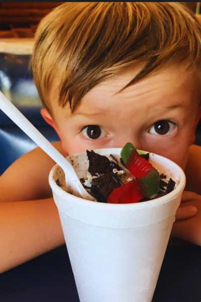 A boy stares over an ice cream candy shake at Tastee Treet in Council Bluffs, Iowa