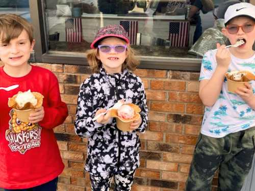 Three kids with waffle cone sundaes at Zaltes, an ice cream shop in Council Bluffs