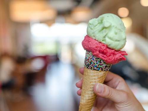 Two colorful scoops on an ice cream cone