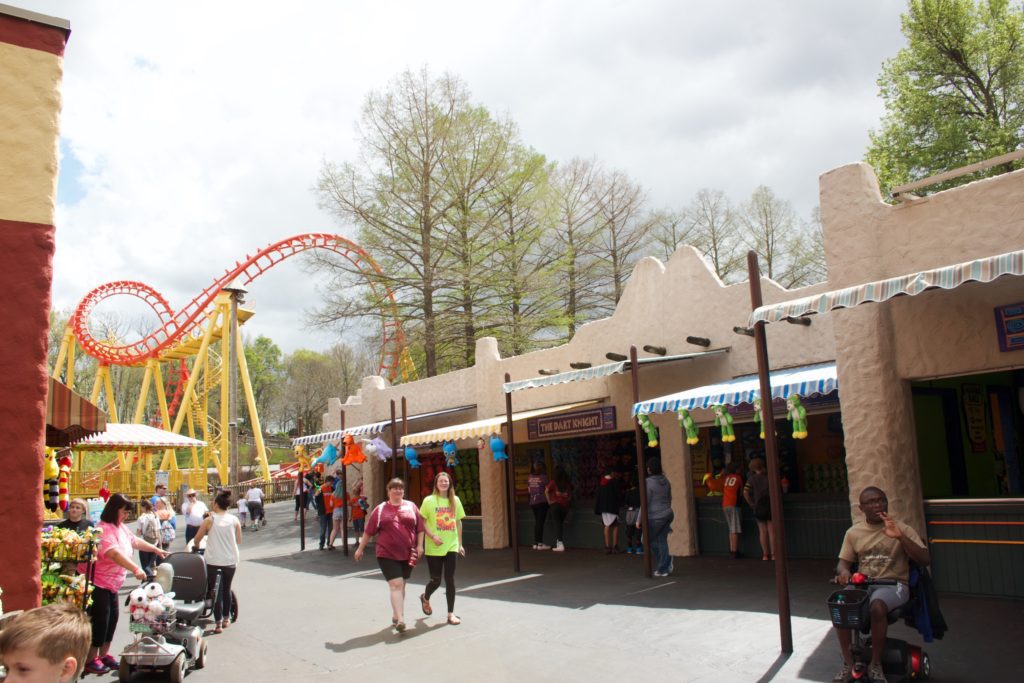 Visitor stroll a midway at Worlds of Fun in Kansas City, Missouri