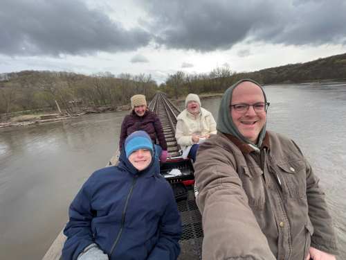 A family rides on Rail Explorers USA's rail bike in early spring in Iowa