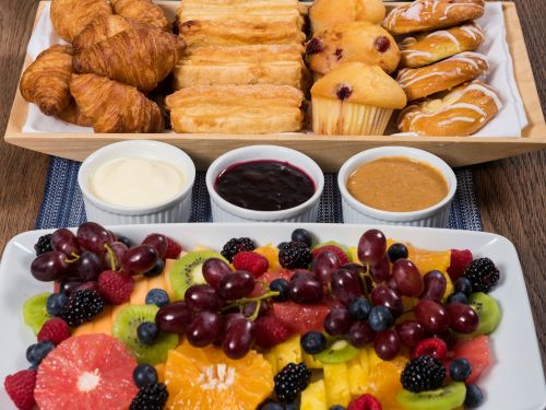 Overhead view of a continental breakfast spread of fruit and pastries