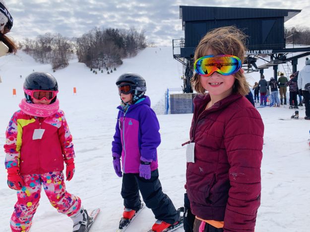 Three young skiers hang out at the base of Seven Oaks Recreation in Boone, Iowa.