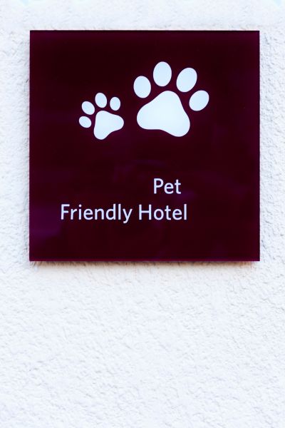 A square sign that reads "Pet Friendly Hotel" with paw prints on it