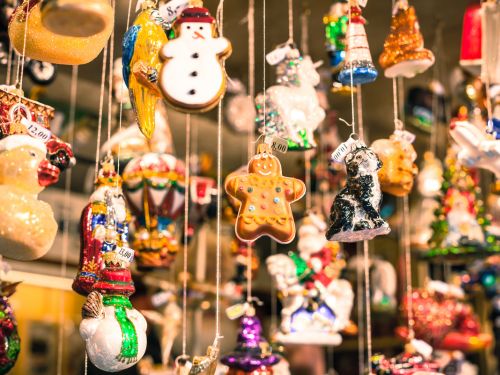 Colorful holiday ornaments hang on display