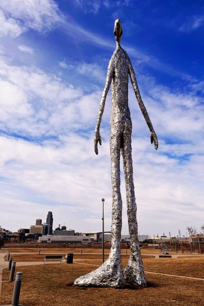 “Looking Up,” a large silver statue shaped like a man, by Thomas Friedman at River’s Edge Park