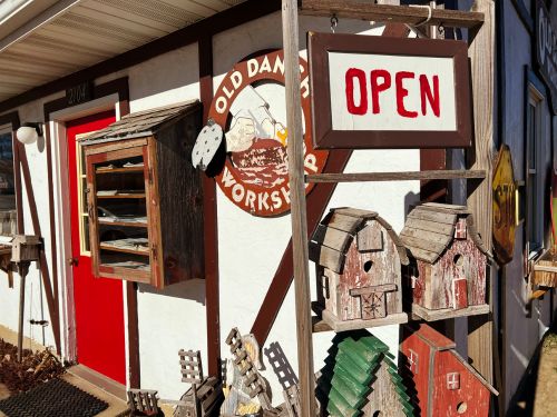 Exterior of the Old Danish Workshop in Elk Horn, Iowa, with an OPEN sign