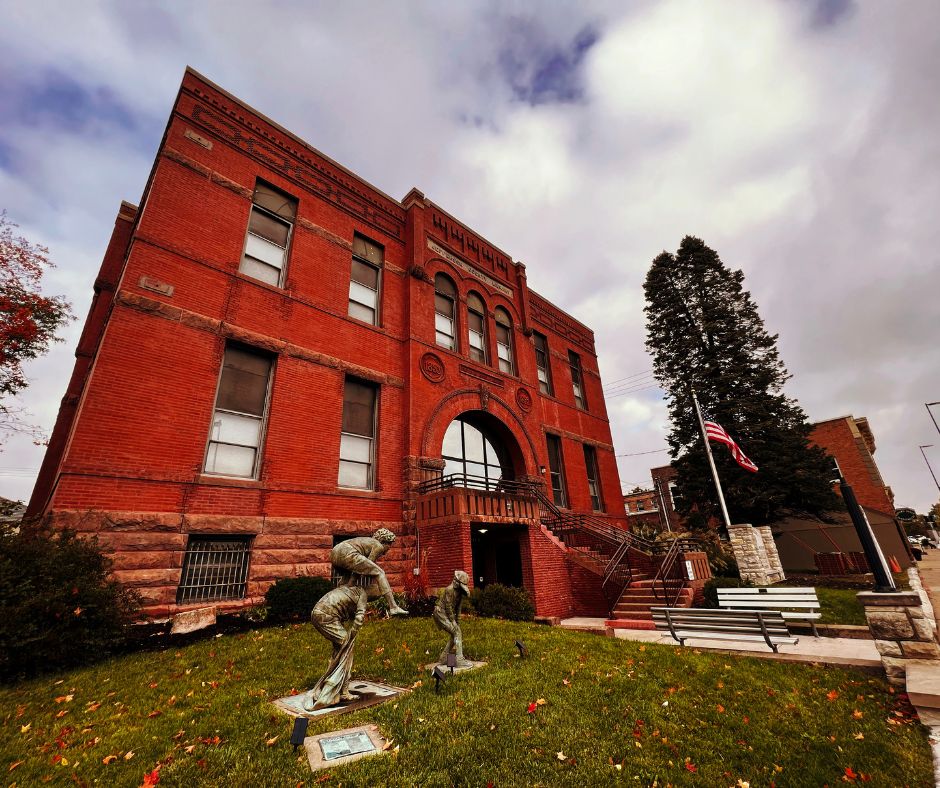 The exterior of the Carnegie Historical Museum, a red brick building in downtown Fairfield, Iowa