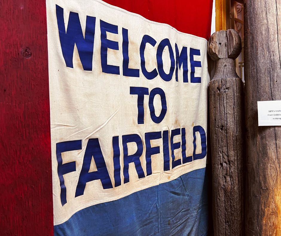 A red, white and blue flag that reads "Welcome to Fairfield"