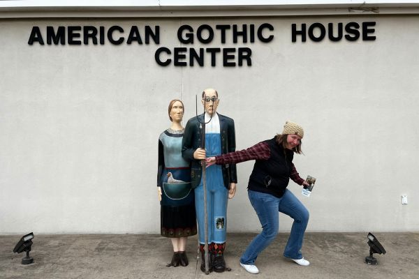 Kim posing with the sculpture in front of the American Gothic House Visitor Center