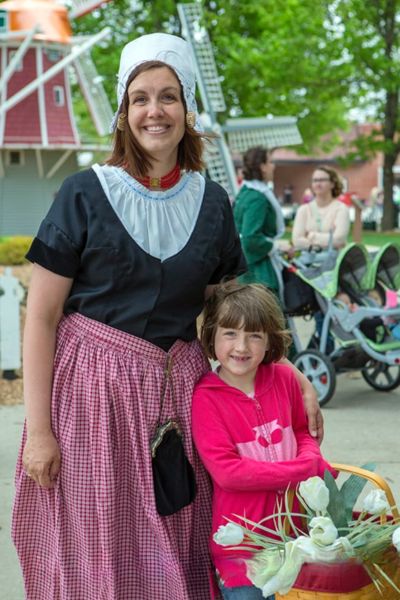 A girl poses with a woman dressed in a traditional Dutch dress in Orange City, Iowa 